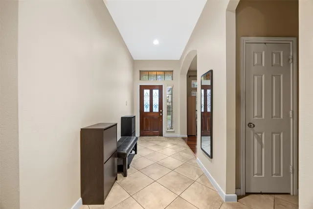 a large white bathroom with a large tub sink vanity granite and a large mirror