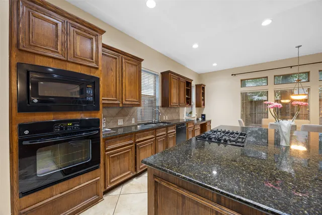 a dining room with furniture and large windows