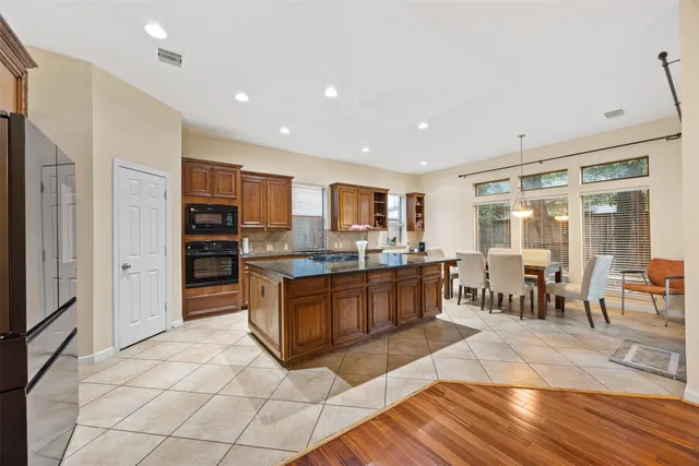 a living room with furniture a large window and a wooden floor