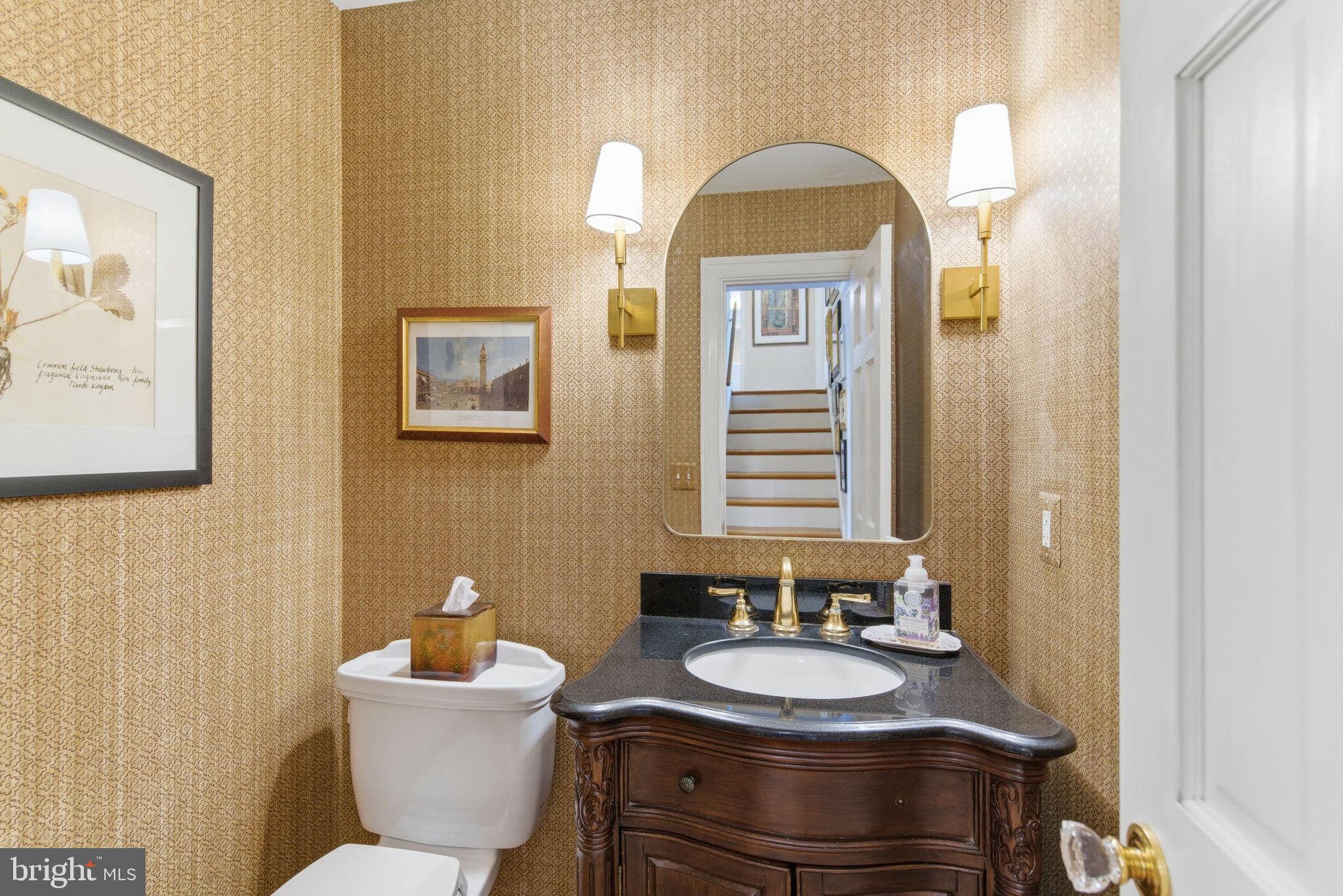 5310 Elliott Road Bethesda, MD 20816 - Photo 31 of 89 a bathroom with a toilet sink and mirror