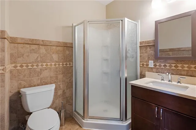 a bathroom with a toilet a sink and a mirror