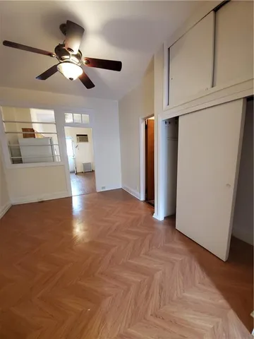 a view of a livingroom with a stove cabinets and wooden floor