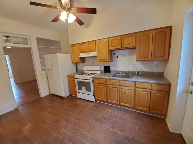 a kitchen with stainless steel appliances a refrigerator sink and cabinets