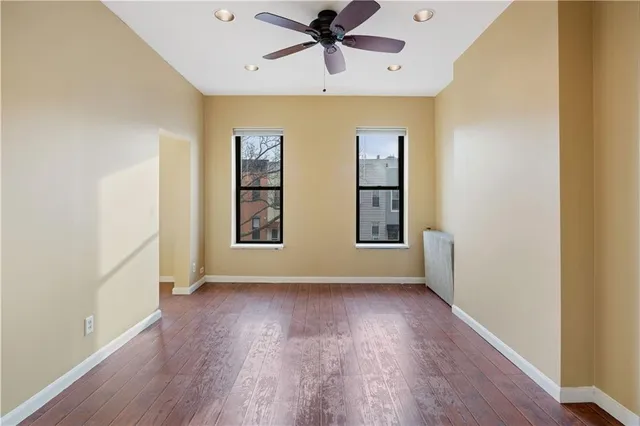 wooden floor in an empty room with a window
