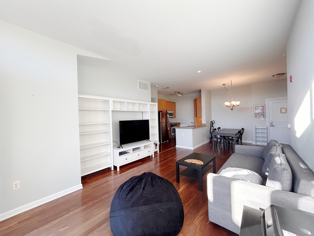 4 Repton Place, Unit 4415 Watertown, MA 02472 - Photo 11 of 25 a living room with furniture and a flat screen tv