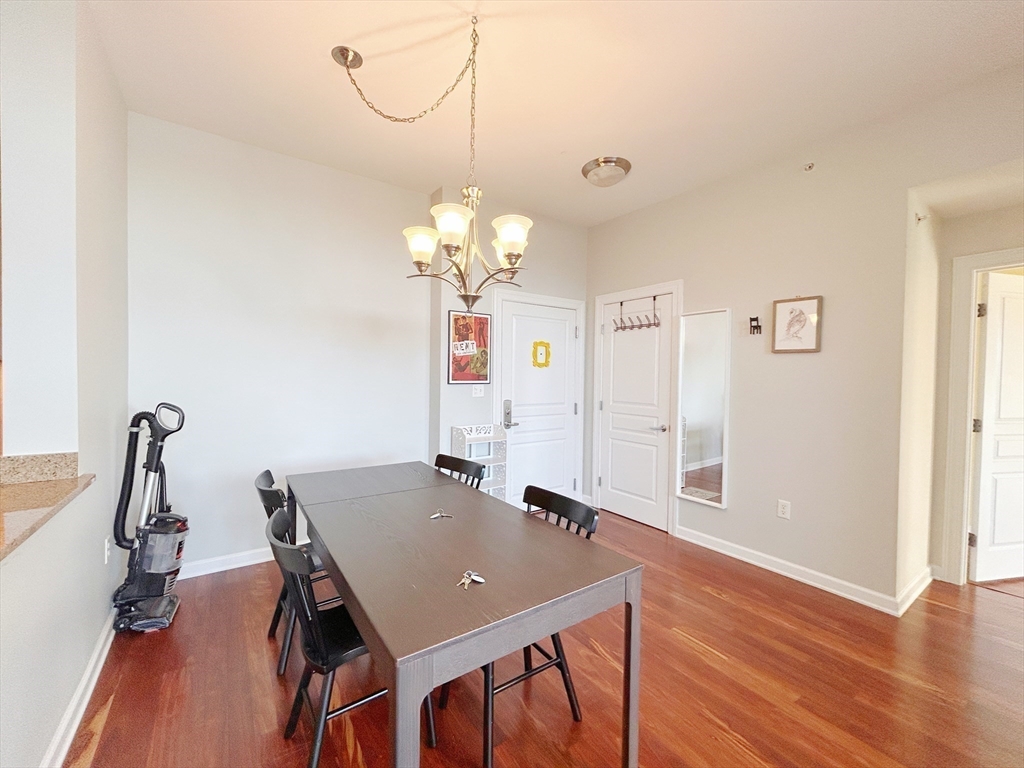 4 Repton Place, Unit 4415 Watertown, MA 02472 - Photo 12 of 25 a view of a dining room with furniture and wooden floor
