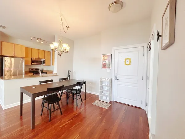 a view of a dining room with furniture and wooden floor