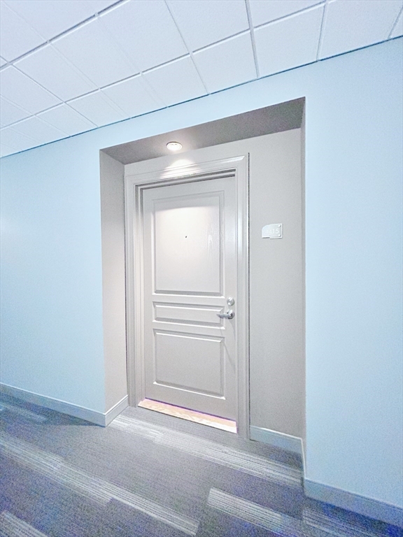 4 Repton Place, Unit 4415 Watertown, MA 02472 - Photo 20 of 25 a view of a livingroom from a hallway