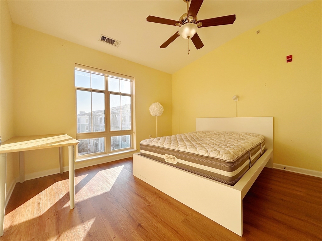 4 Repton Place, Unit 4415 Watertown, MA 02472 - Photo 6 of 25 a living room with hard wood floors and a ceiling fan