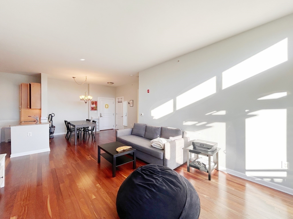 4 Repton Place, Unit 4415 Watertown, MA 02472 - Photo 10 of 25 a living room with furniture and a wooden floor