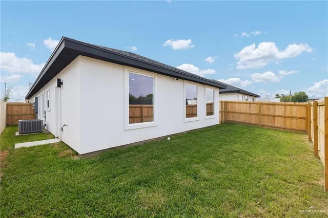 an aerial view of residential houses with yard
