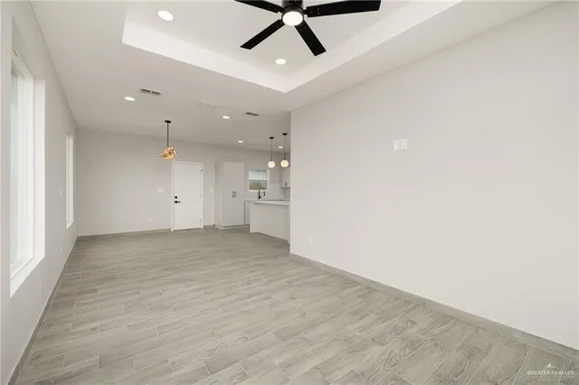 an empty room with a empty space and a ceiling fan