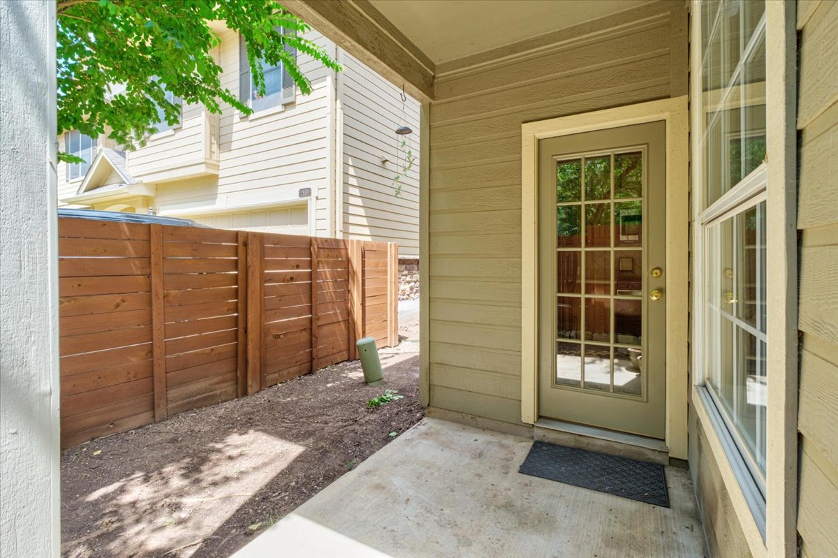 11000 Anderson Mill Road, Unit 11 Austin, TX 78750 - Photo 24 of 34 A private outdoor patio offers a quiet retreat, bordered by a tasteful wooden fence.