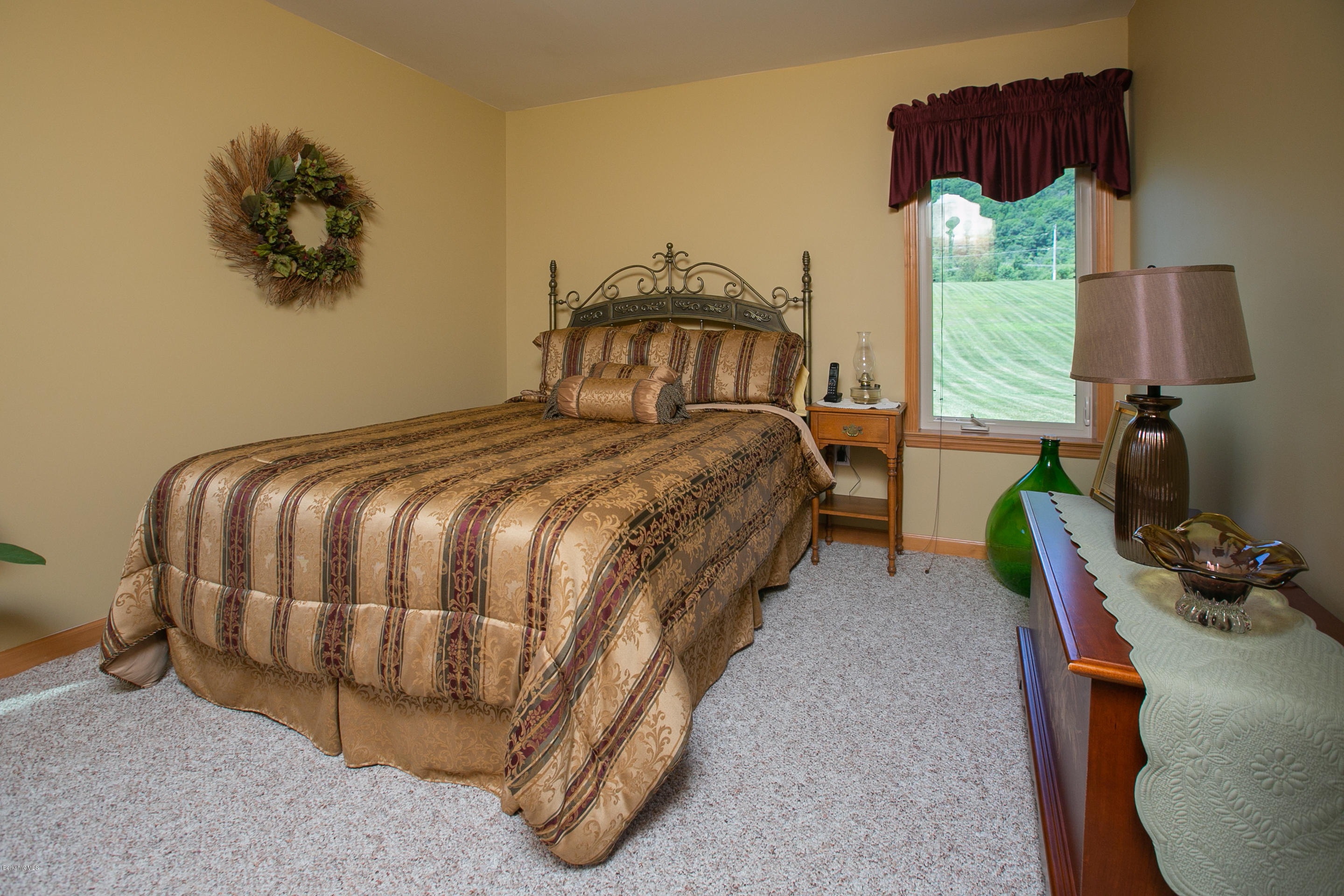 595 Lanesboro Road Cheshire, MA 01225 - Photo 20 of 32 a bedroom with a bed a window and dresser