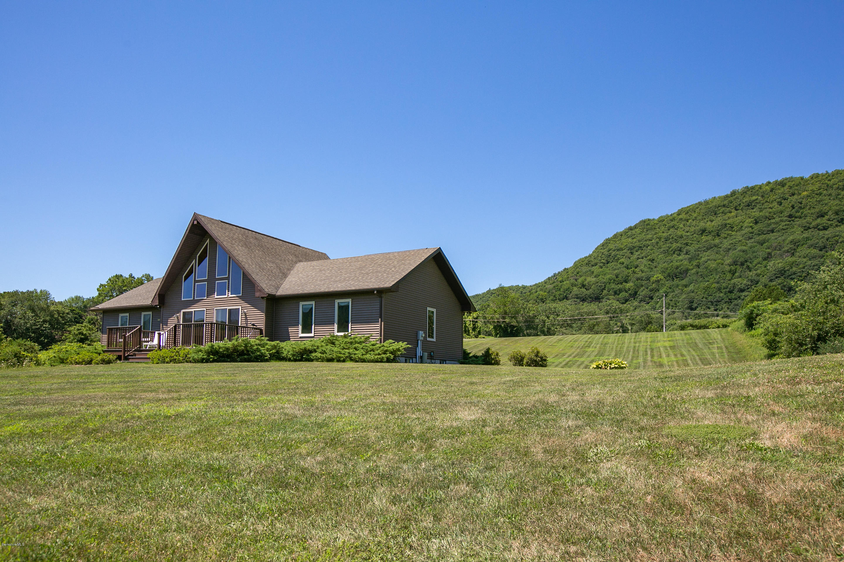 595 Lanesboro Road Cheshire, MA 01225 - Photo 25 of 32 a house that is sitting in the grass with large trees