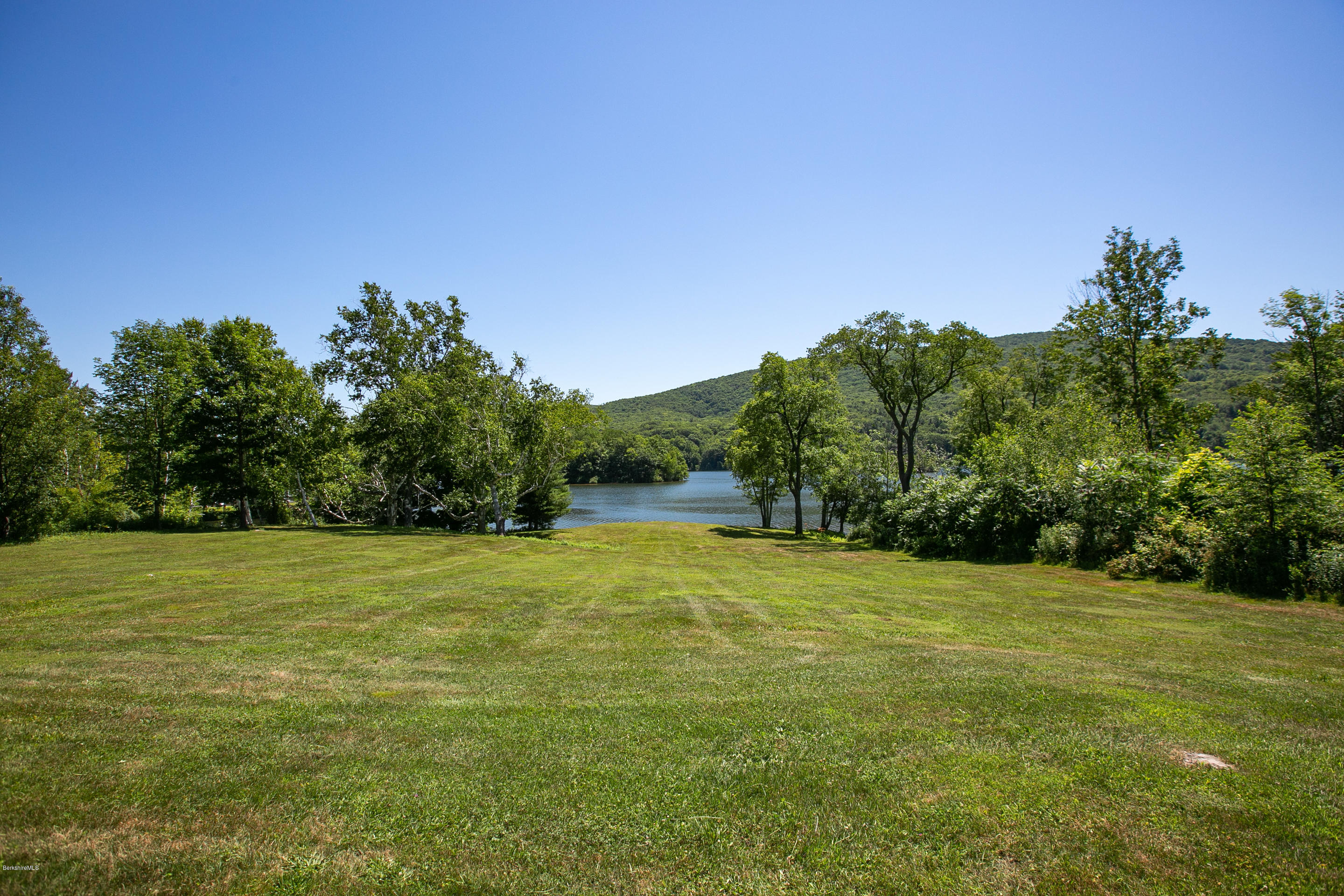 595 Lanesboro Road Cheshire, MA 01225 - Photo 4 of 32 a view of a field with trees in the background