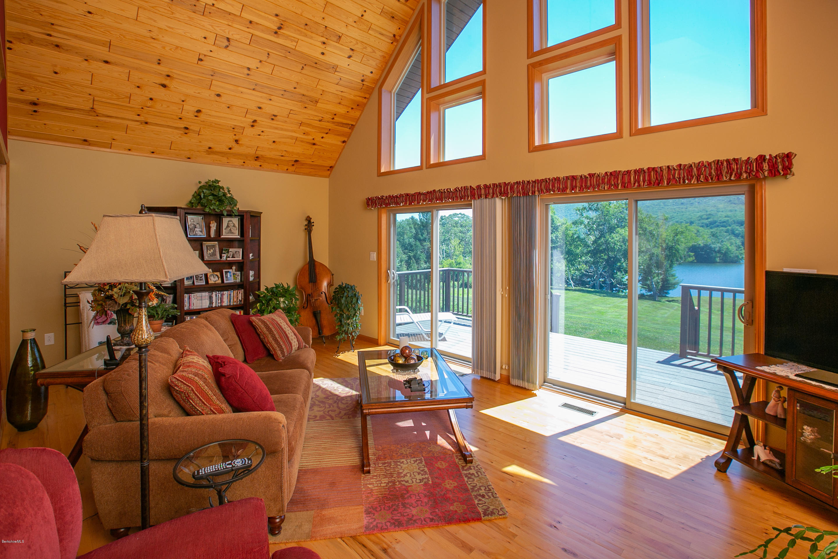595 Lanesboro Road Cheshire, MA 01225 - Photo 6 of 32 a living room with furniture a flat screen tv and floor to ceiling window