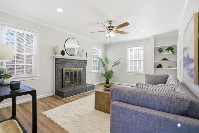 a living room with furniture a window and a fireplace