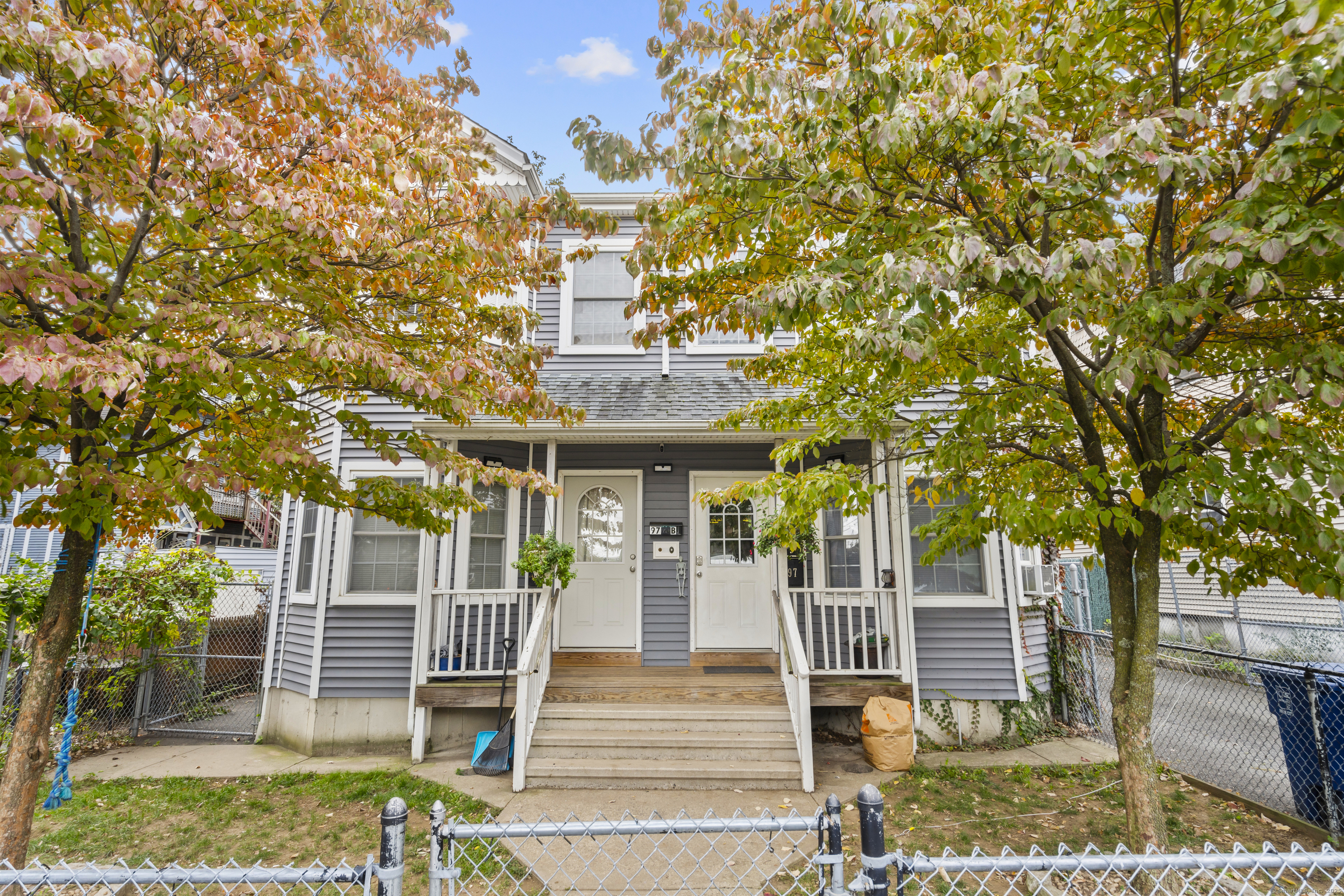 front view of a house with a tree