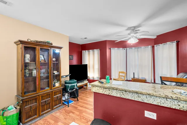 a kitchen with a refrigerator and a stove top oven