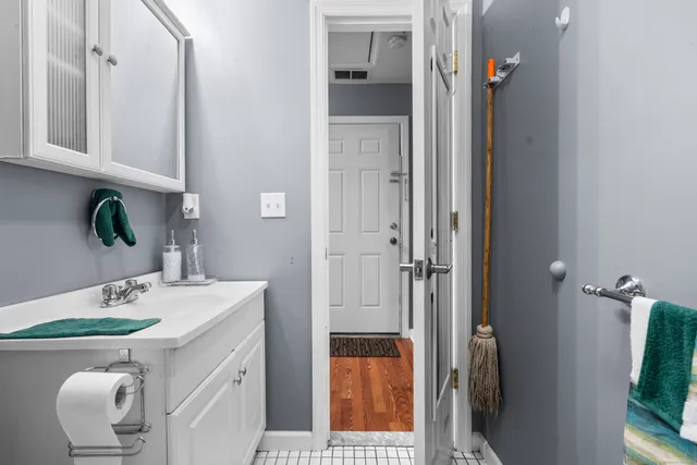 a bathroom with a toilet a sink and a mirror