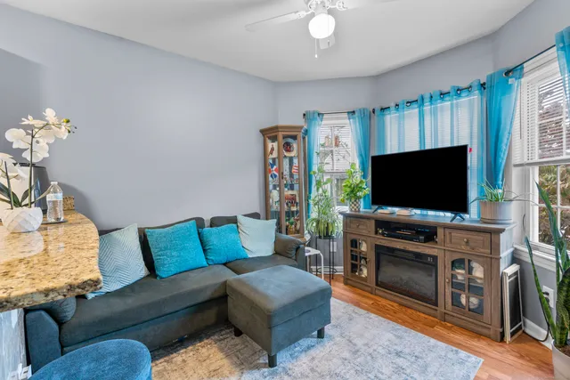 a kitchen with stainless steel appliances kitchen island granite countertop a sink dishwasher and cabinets with wooden floor