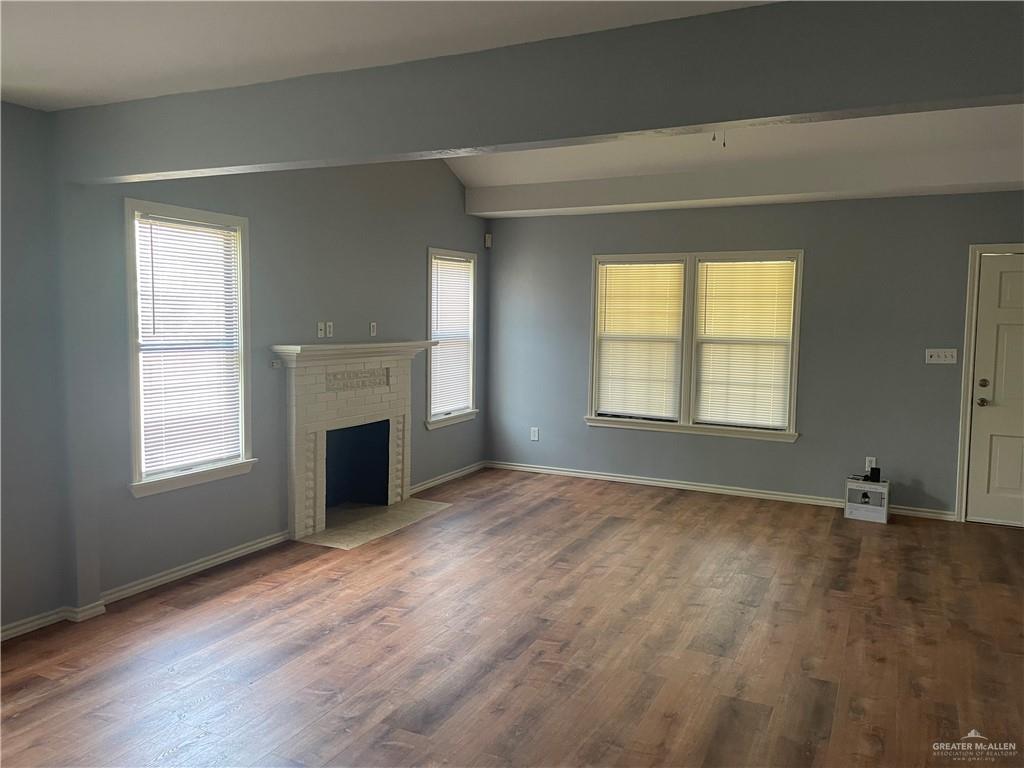 329 North 8th Street McAllen, TX 78501 - Photo 4 of 13 an empty room with windows and a fireplace