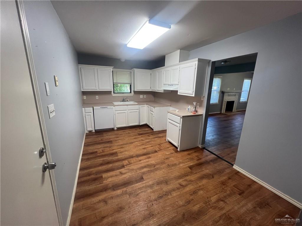 329 North 8th Street McAllen, TX 78501 - Photo 5 of 13 a room with wooden floors and white walls