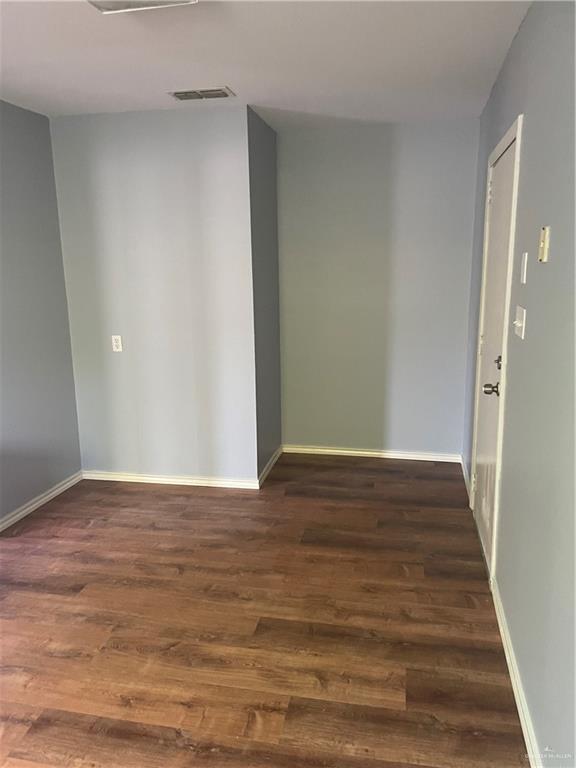 329 North 8th Street McAllen, TX 78501 - Photo 8 of 13 a view of an empty room with wooden floor and a window