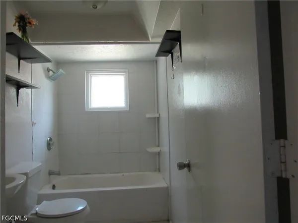 a bathroom with a shower and a toilet