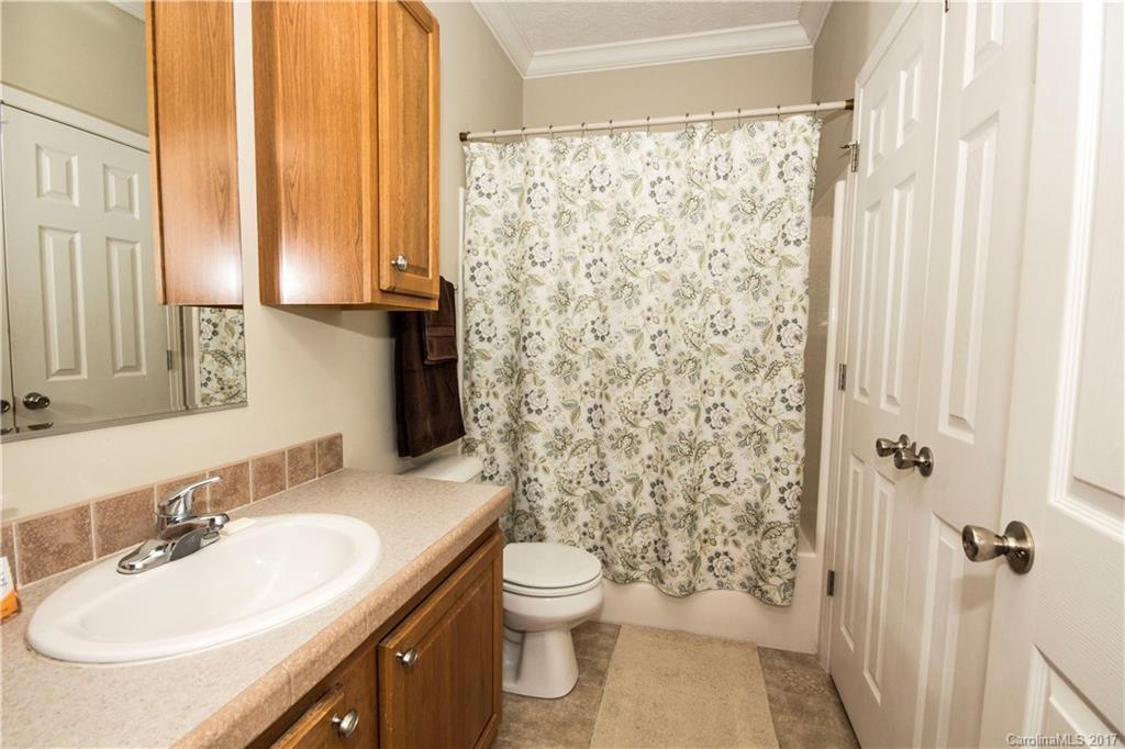 423 Ridgedale Road Clyde, NC 28721 - Photo 14 of 19 a bathroom with a granite countertop sink toilet and shower