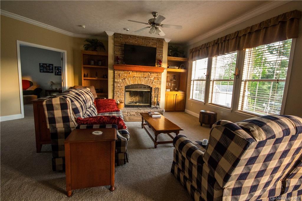 423 Ridgedale Road Clyde, NC 28721 - Photo 6 of 19 a living room with furniture fireplace and flat screen tv