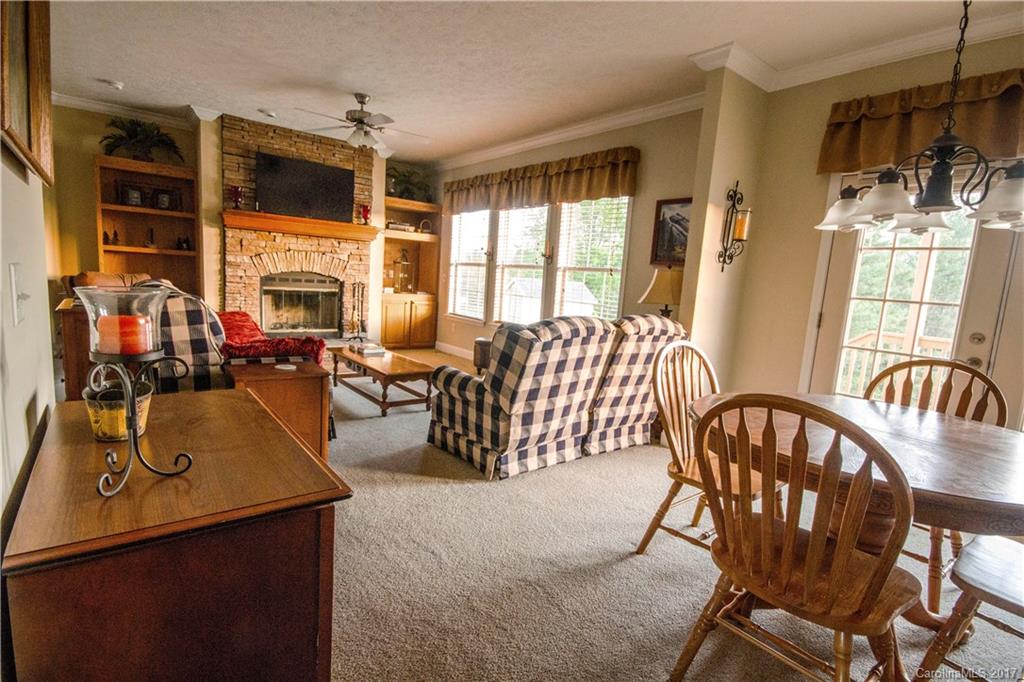 423 Ridgedale Road Clyde, NC 28721 - Photo 7 of 19 a living room with fireplace furniture and a large window