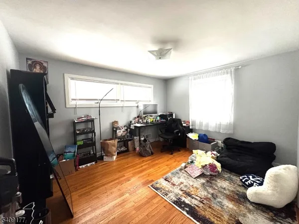 a living room with furniture rug and a window