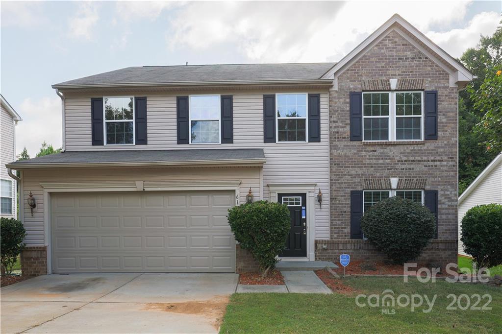 6154 Trotters Ridge Road Charlotte, NC 28227 - Photo 8 of 28 a front view of a house with a yard and garage