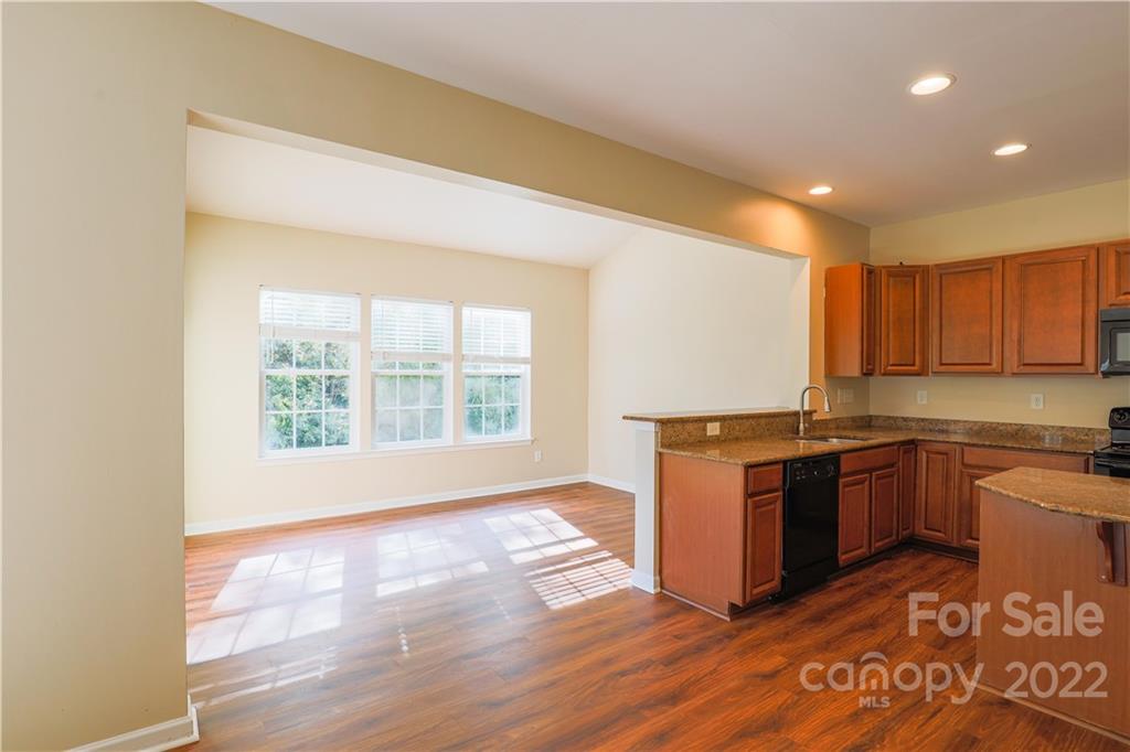 6154 Trotters Ridge Road Charlotte, NC 28227 - Photo 9 of 28 a kitchen with stainless steel appliances granite countertop a stove a sink and a microwave