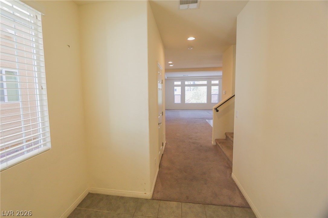 6418 Jackson Spring Road Las Vegas, NV 89118 - Photo 3 of 20 A welcoming entryway with recessed lighting leads to a spacious living area and staircase.