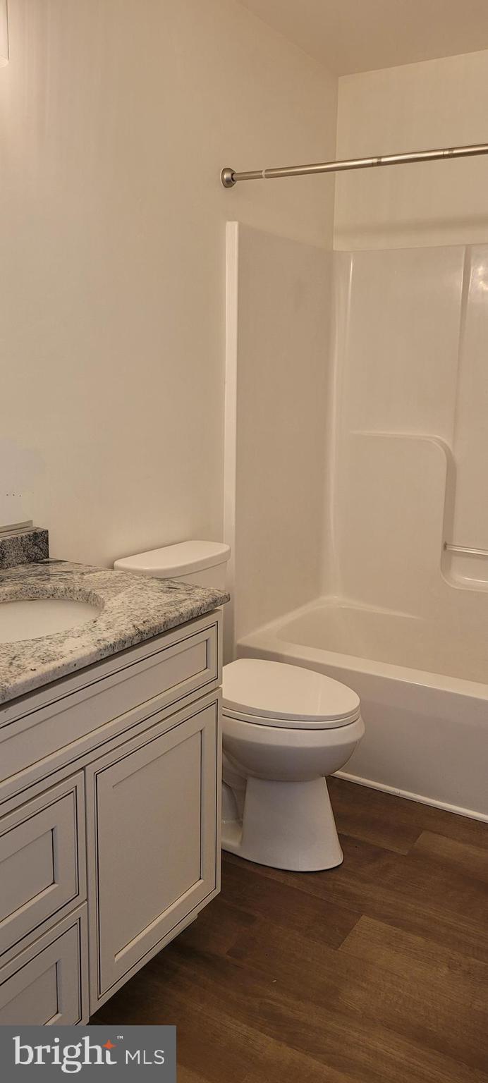 4163 Telegraph Road Elkton, MD 21921 - Photo 13 of 23 a bathroom with a granite countertop toilet a sink and a shower