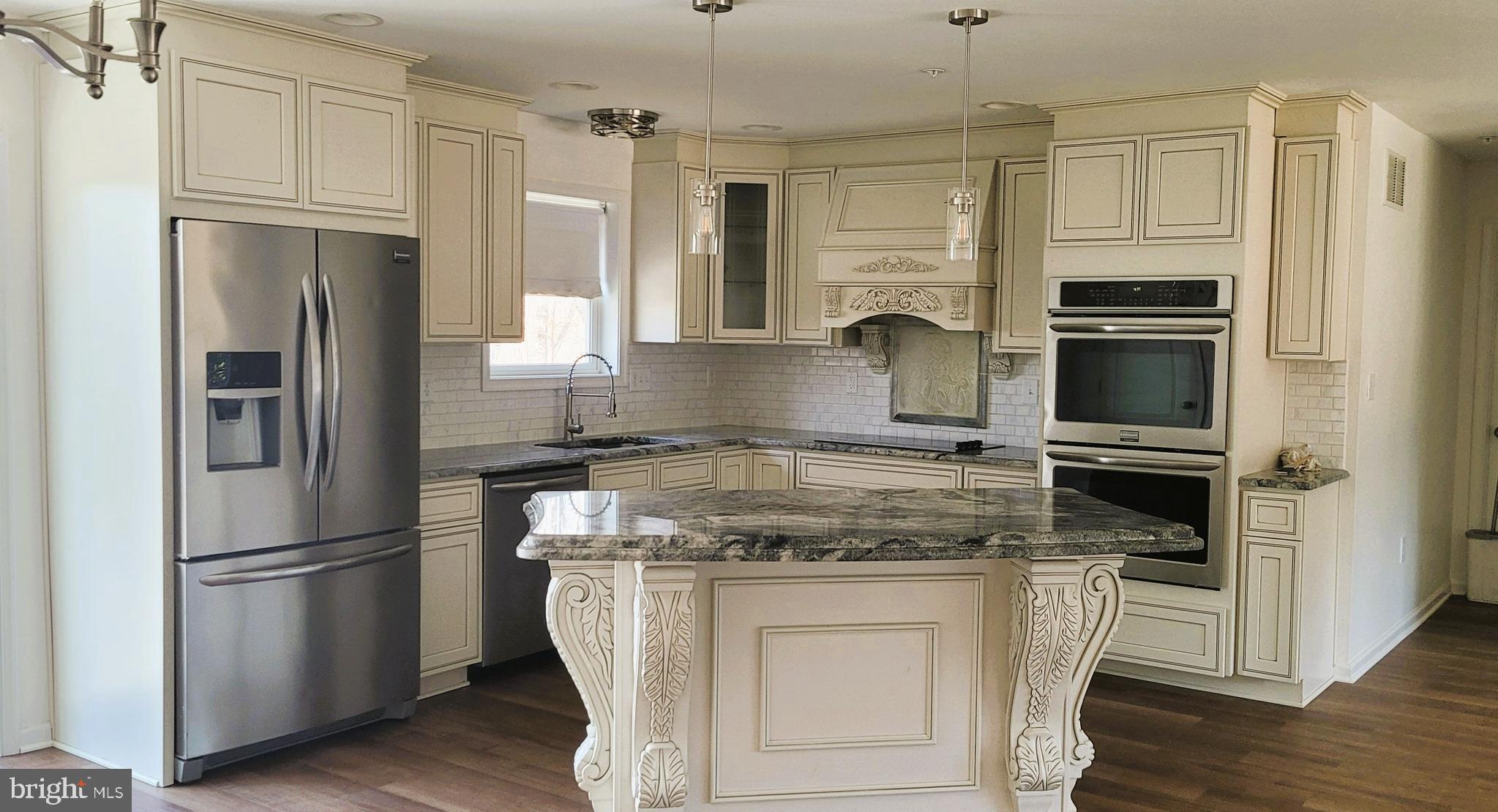 4163 Telegraph Road Elkton, MD 21921 - Photo 7 of 23 a kitchen with kitchen island granite countertop appliances cabinets and a counter space