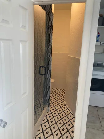 a kitchen with stainless steel appliances kitchen island granite countertop a refrigerator and a sink