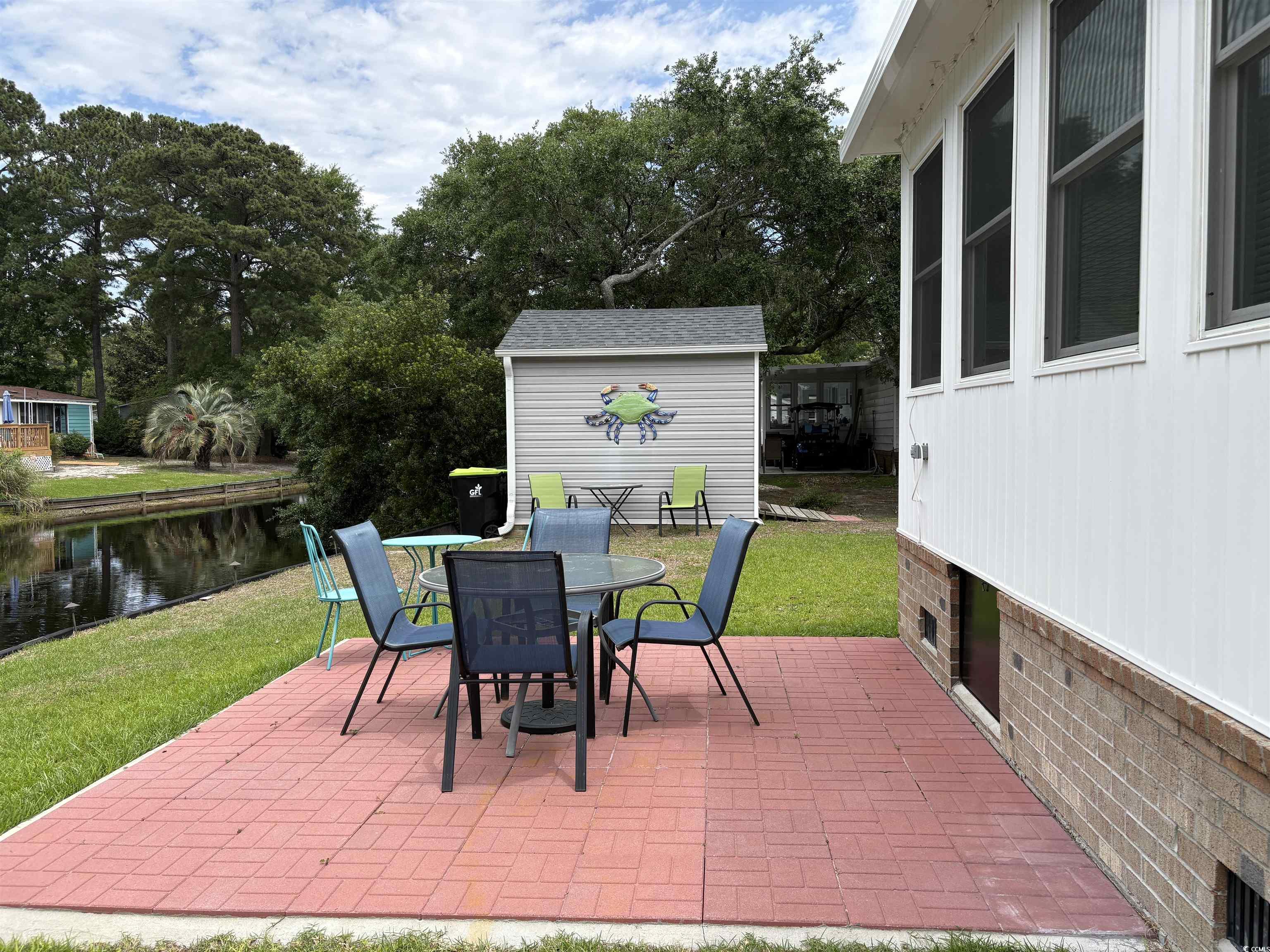 3248 Pecan Trail Murrells Inlet, SC 29576 - Photo 26 of 29 View of green lawn with a patio area and a water v