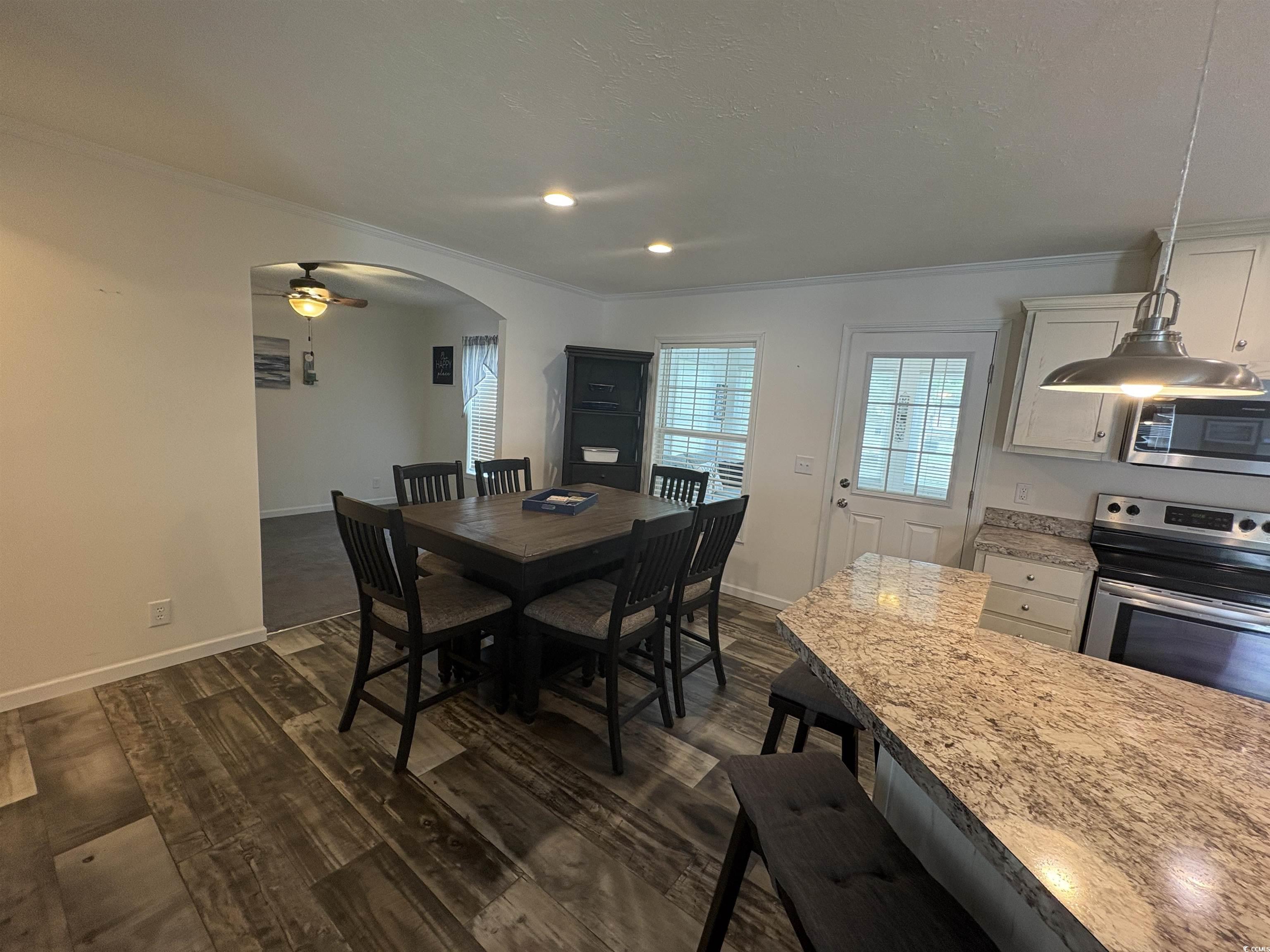 3248 Pecan Trail Murrells Inlet, SC 29576 - Photo 7 of 29 Dining space with ornamental molding, dark wood-st