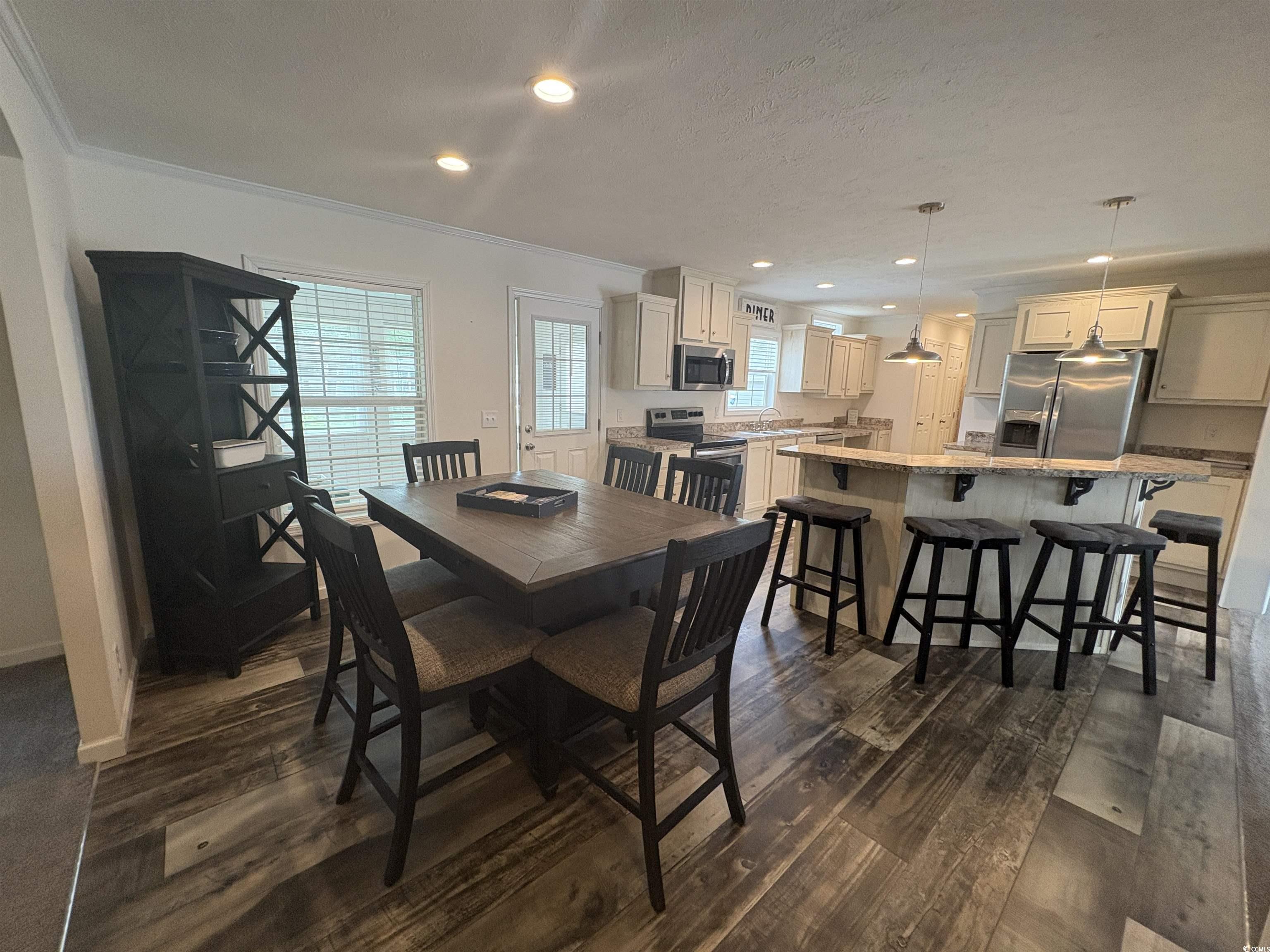 3248 Pecan Trail Murrells Inlet, SC 29576 - Photo 8 of 29 Dining space with ornamental molding, dark wood-st