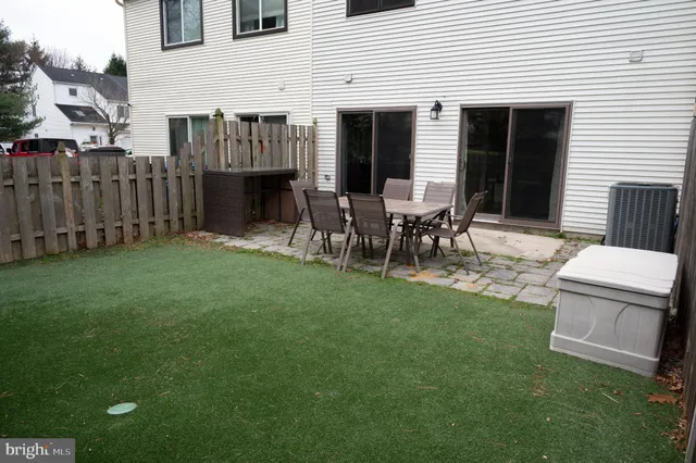 a view of a house with backyard and a chair