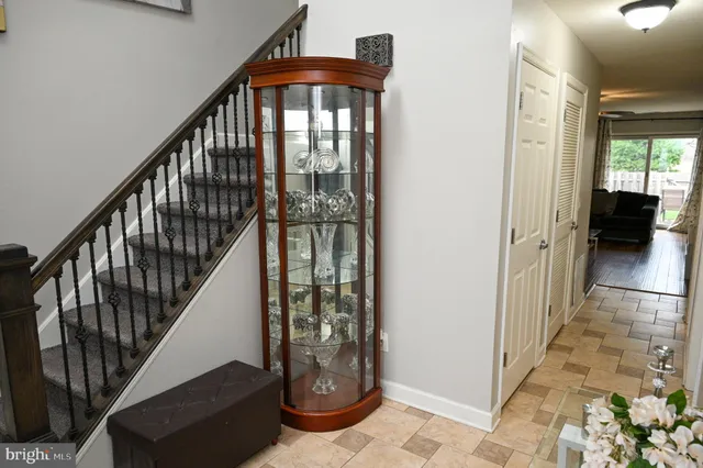a view of staircase with lots of frames on wall and a window