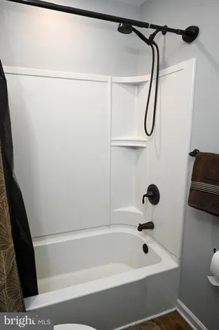 a bathroom with a bathtub and a shower