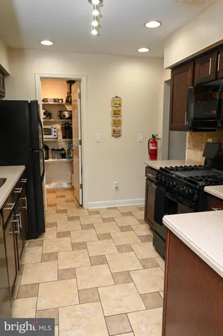 a kitchen with stainless steel appliances a stove a sink and a refrigerator