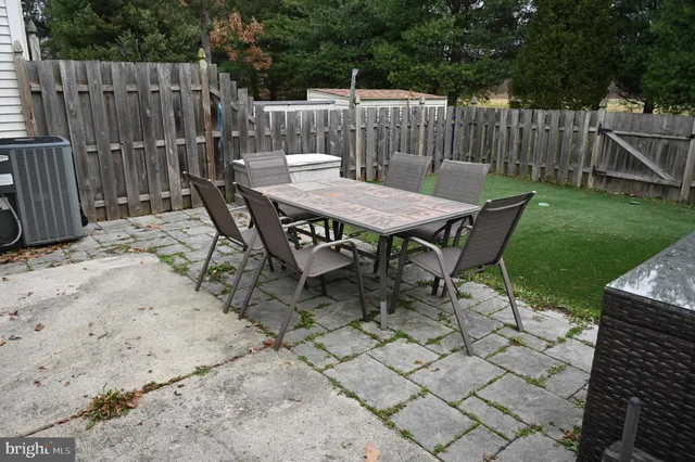 a view of a chairs and table in backyard
