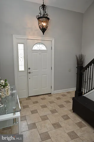 a view of a livingroom with wooden floor and a chandelier