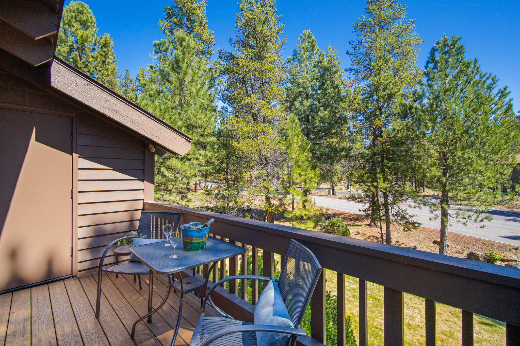57305 Beaver Ridge Loop, Unit 8 Sunriver, OR 97707 - Photo 13 of 25 a view of a balcony with chairs and wooden fence